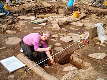 Sarah records the hearth in Structure 10. Sarah records the hearth in Structure 10.