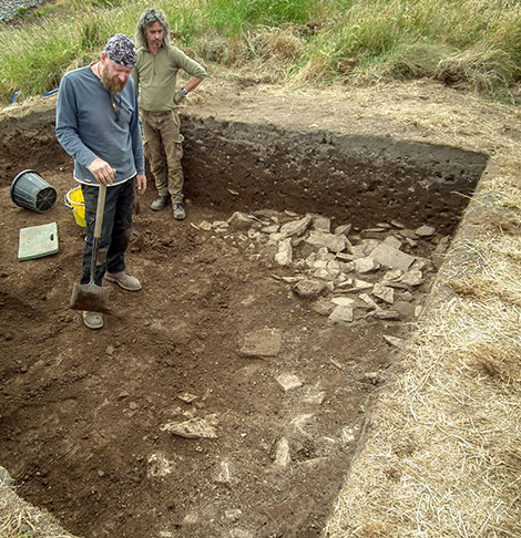 Trench supervisor Mike (left) and Marcus contemplate the spread of rubble found at the top of Trench Y.