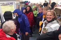 A-group-of-hardy-and-very-cheerful-American-visitors-huddle-in-the-site-shop-to-escape-the-monsoon-like-rain